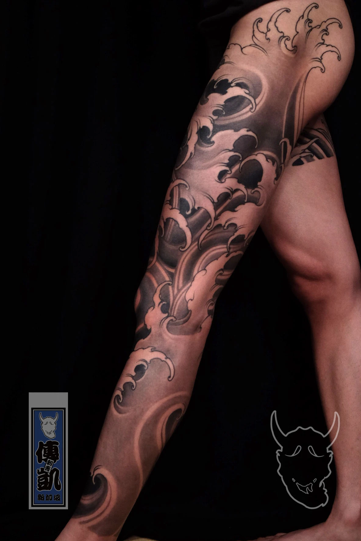 New Traditional Japanese full leg tattoo with black and grey waves, symbolizing strength and fluid energy. CK Tattoo Singapore.