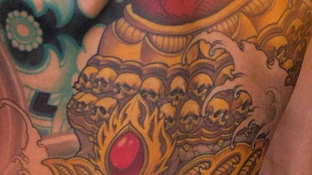 New Traditional Japanese tattoo of a Tibetan skull and lotus, full backpiece with intricate gold and red detailing.