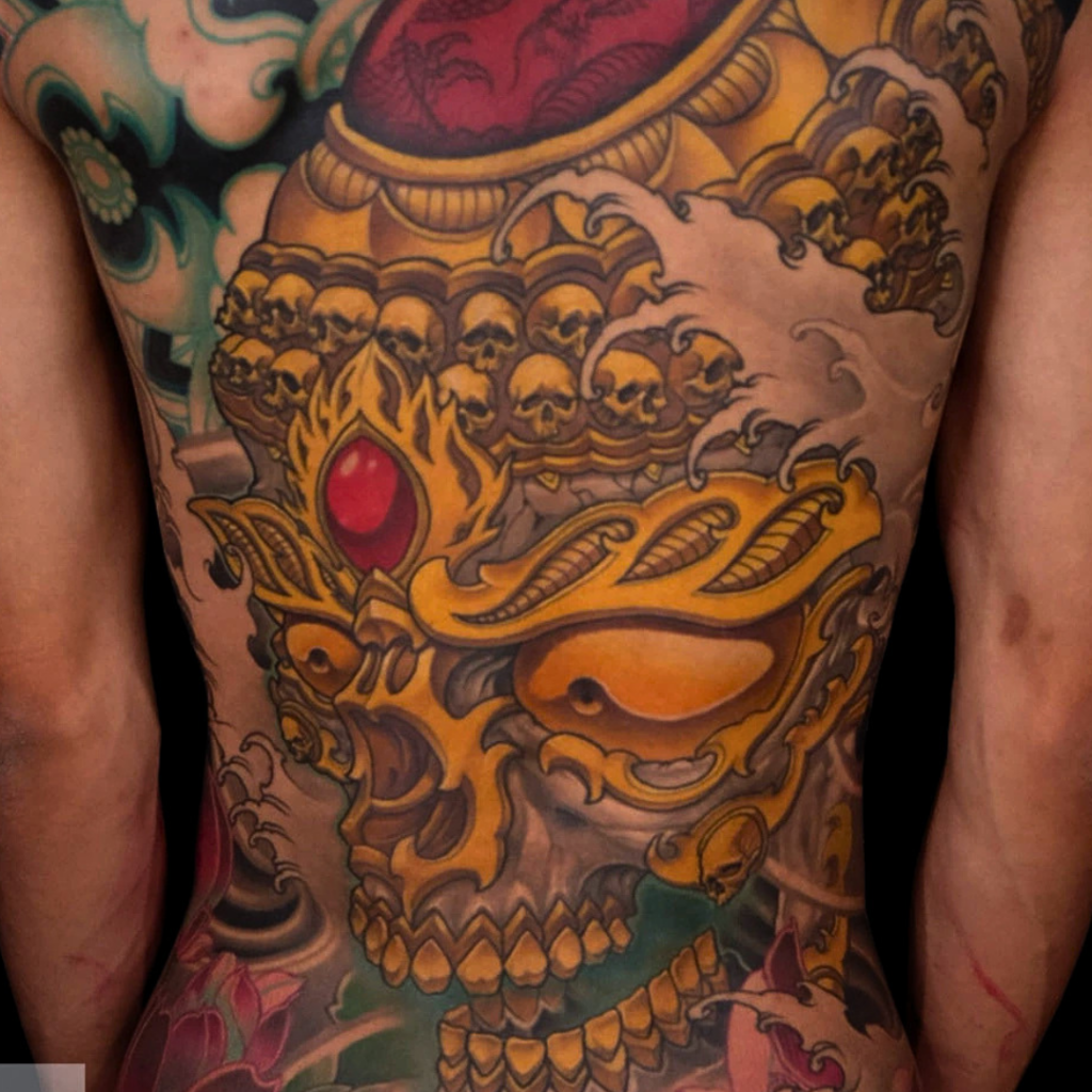 Tibetan skull full back tattoo with crown of skulls
