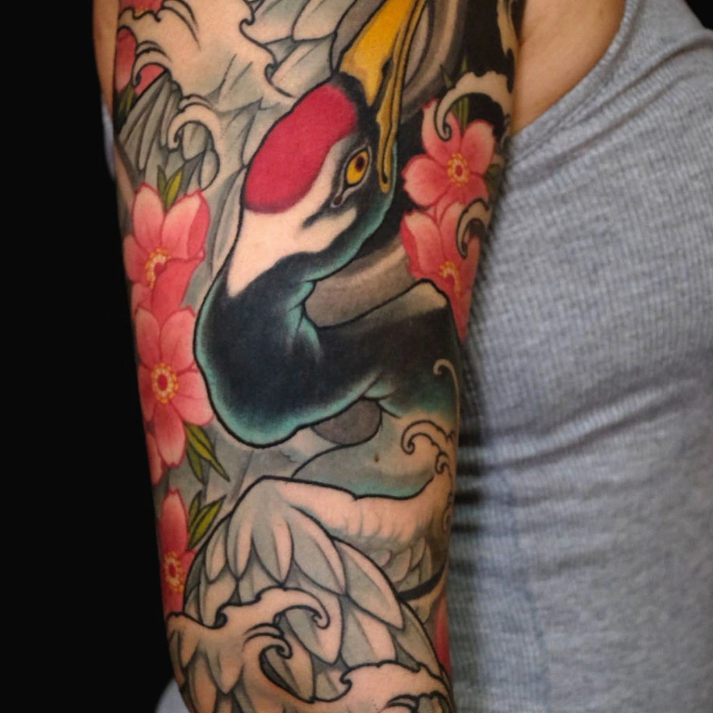 Japanese crane tsuru sleeve tattoo with cherry blossoms peony and waves by CK Tattoo Singapore
