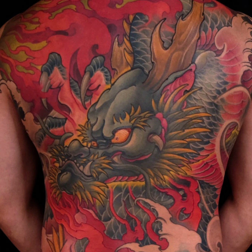 Japanese dragon full back tattoo with red flames sacred clouds and waves by CK Tattoo Singapore
