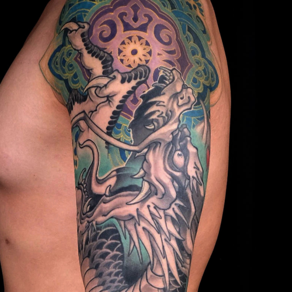 Black and grey Japanese dragon full sleeve tattoo with mandala shoulder and waves by CK Tattoo Singapore