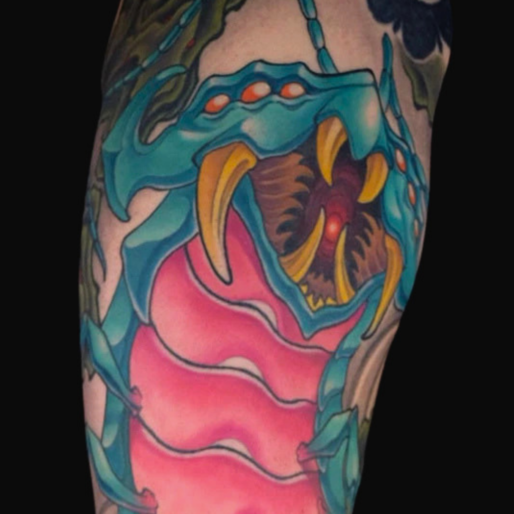 Japanese mukade giant centipede sleeve tattoo with teal body pink underbelly and fangs by CK Tattoo Singapore