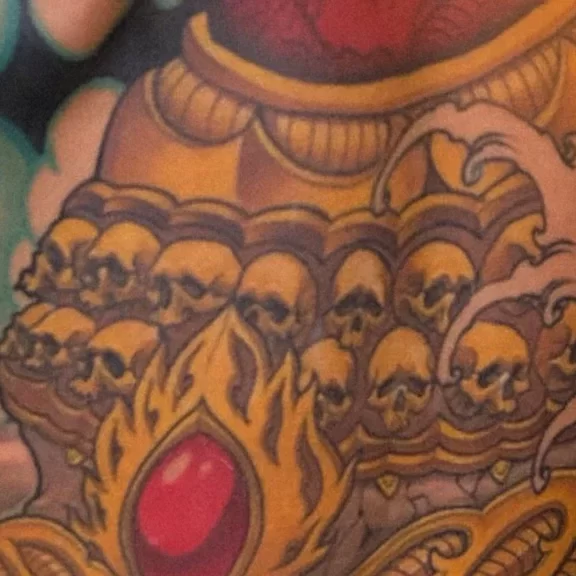 New Traditional Japanese tattoo of a Tibetan skull and lotus, full backpiece with intricate gold and red detailing.